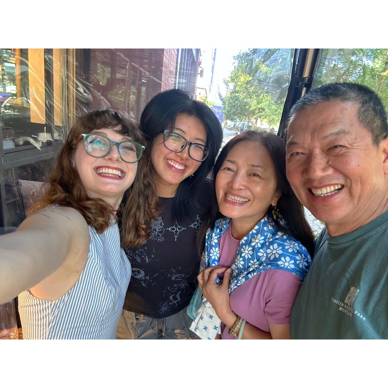 Ashley taking a selfie with three loved ones, everyone beaming.